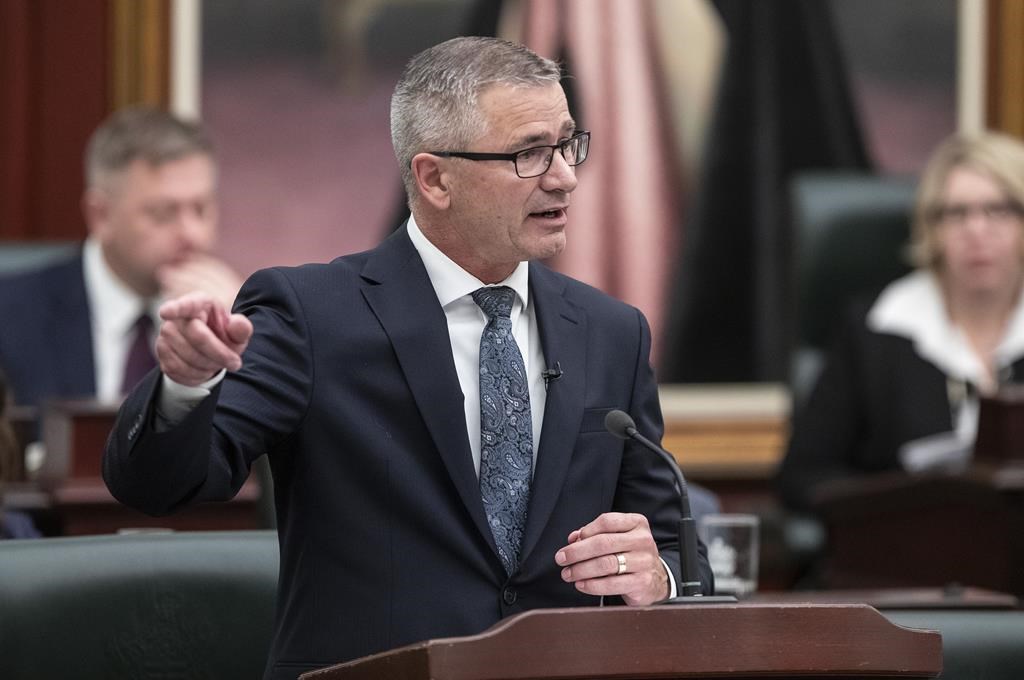 Alberta Finance Minister Travis Toews delivers the 2023 budget, in Edmonton on Tuesday, Feb. 28, 2023. Alberta has introduced legislation that would require it to keep a tight rein on spending, save for a rainy day and continue to pay down debt.