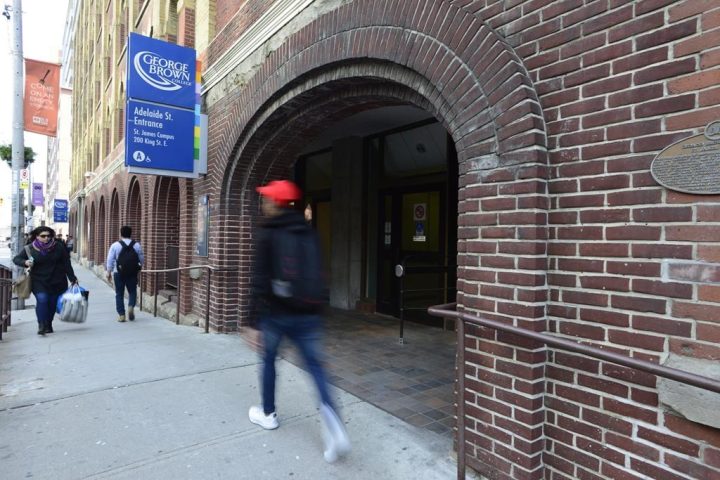 People walk near an entrance to George Brown College in Toronto on Tuesday, Nov. 21, 2017. The downtown Toronto college says it is investigating after a guest speaker used the N-word during a case study presentation on Wednesday.