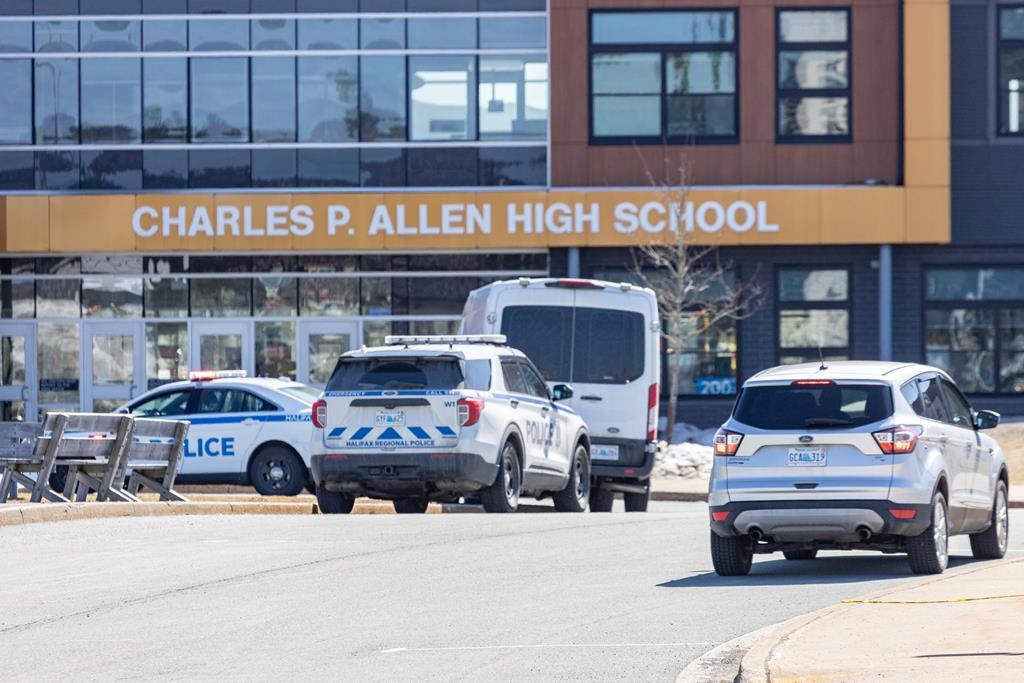 Police monitor the situation at Charles P. Allen High School in Halifax on March 20, 2023. THE CANADIAN PRESS/Riley Smith.