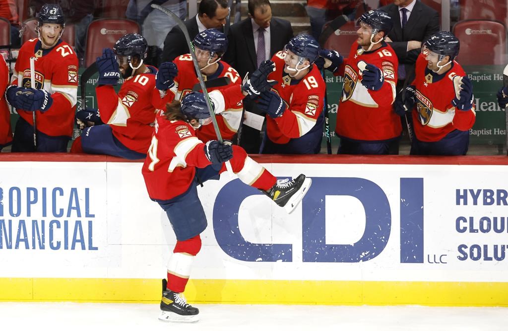 Florida Panthers left wing Ryan Lomberg, front, celebrates after his goal against the New York Rangers during the first period of an NHL hockey game Saturday, March 25, 2023, in Sunrise, Fla.