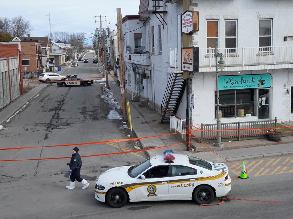 Police tape cordons off the scene after a Quebec provincial police officer was killed while trying to arrest a man in Louiseville, Que. on Tuesday.