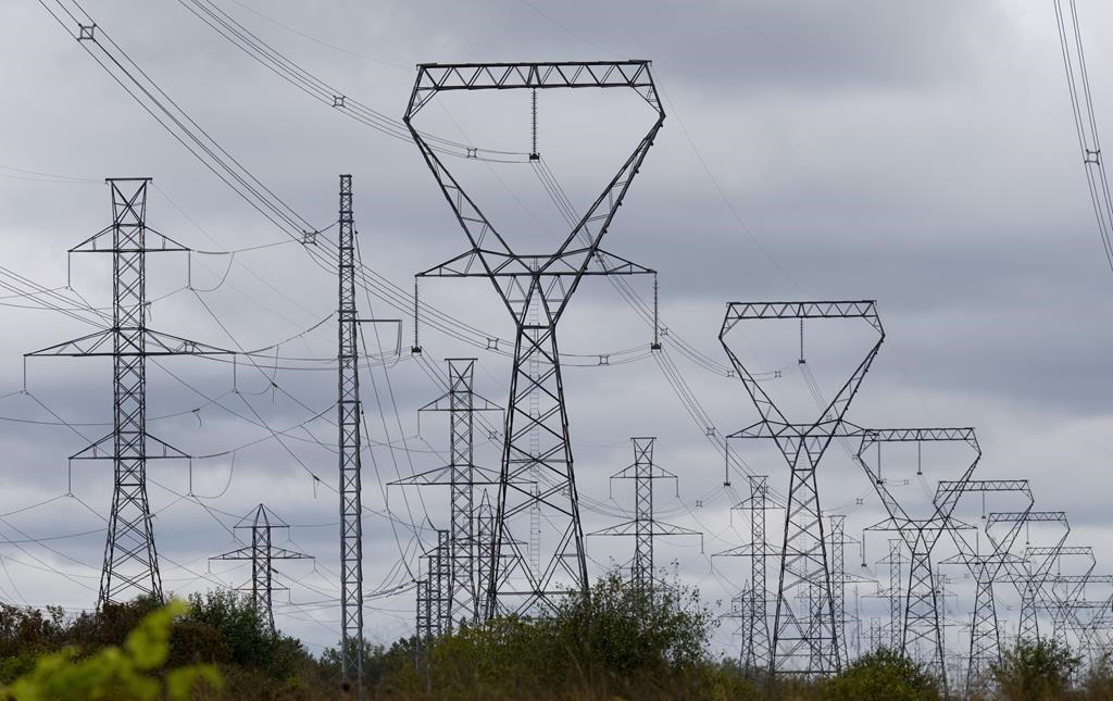 Power lines are seen against cloudy skies near Murvale, Ont., northwest of Kingston, Wednesday, Sept. 7, 2022. Ontario companies can now purchase clean energy credits, and the energy minister says proceeds will go into a fund to support the development of new clean energy projects. 