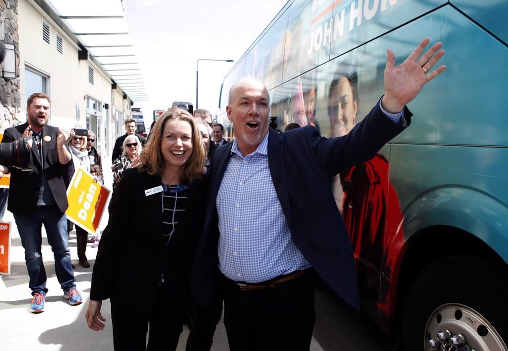 John Horgan and Mitzi Dean meet with supporters during a campaign stop in Victoria, B.C., on Friday, April 28, 2017. Dean, the child and family development minister, says families fostering kids 11 and under will see their payments increase by $450 a month to $1,465 per child, while caregivers for those 12 to 19 will see a $531 monthly increase to $1,655 per child.THE CANADIAN PRESS/Chad Hipolito.
