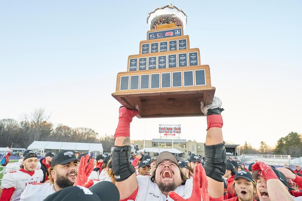 Laval’s Antoine Dean Rios hoist the Vanier Cup following the Rouge et Or’s victory over the Saskatchewan Huskies at Alumni Stadium in London, Ont., Saturday, Nov. 26, 2022. U Sports, Canadian university sport's governing body, announced Thursday its national championship football game will be played at Richardson Memorial Stadium, home of the Queen's Gaels, in 2023 and '24. THE CANADIAN PRESS/Geoff Robins.