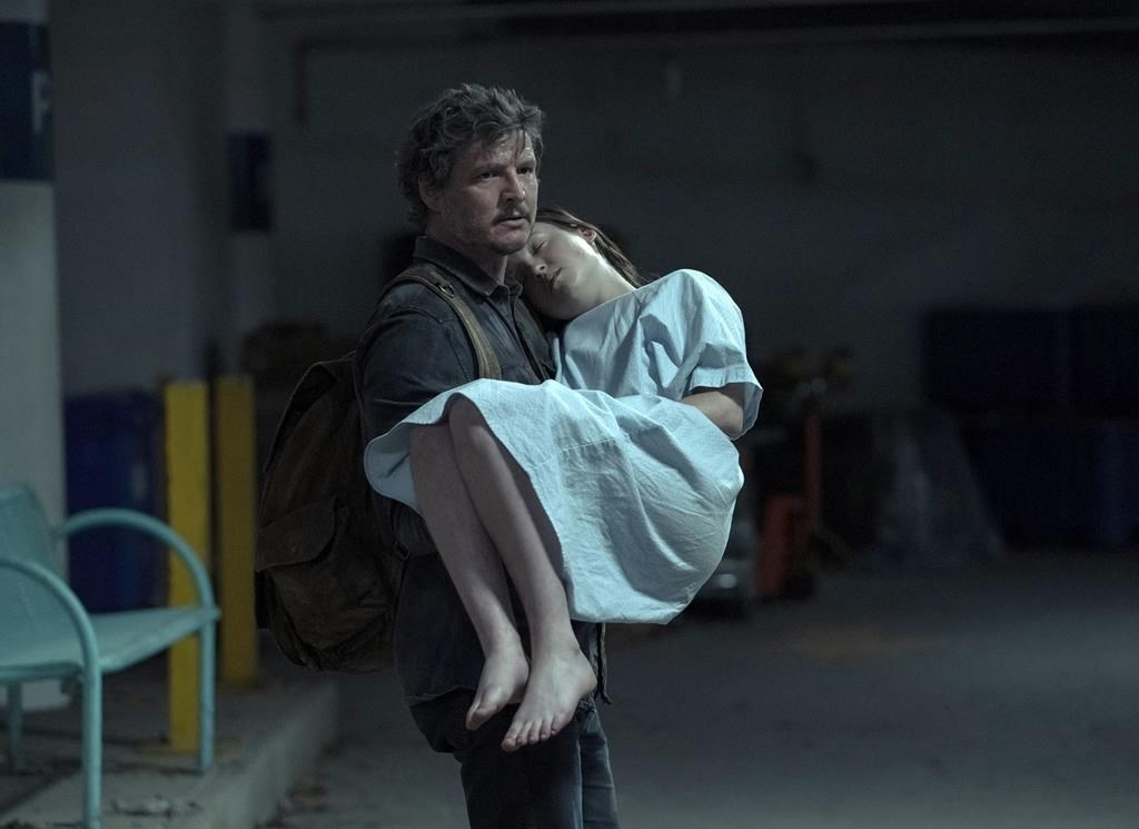 This image released by HBO shows Pedro Pascal, left, and Bella Ramsey in a scene from the series "The Last of Us." Vancouver Mayor Ken Sim says he's looking forward to seeing a post-apocalyptic version of city hall after announcing that hit HBO TV series "The Last of Us" will film season two in the city, moving from Alberta. 