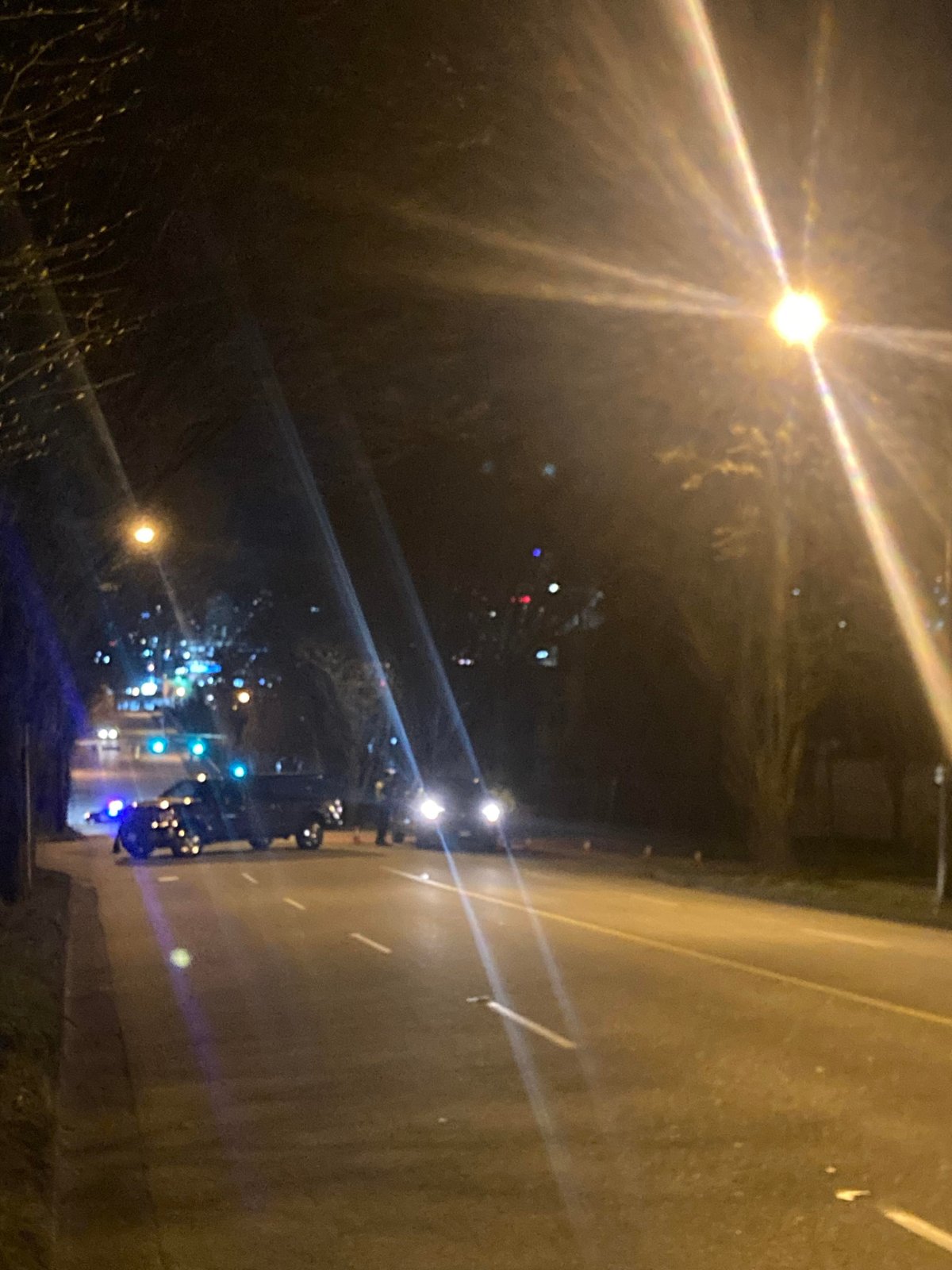 Vancouver police block off a section of East 1st Avenue at Woodland Drive after a woman was struck by a vehicle while crossing the street on March 28, 2023.