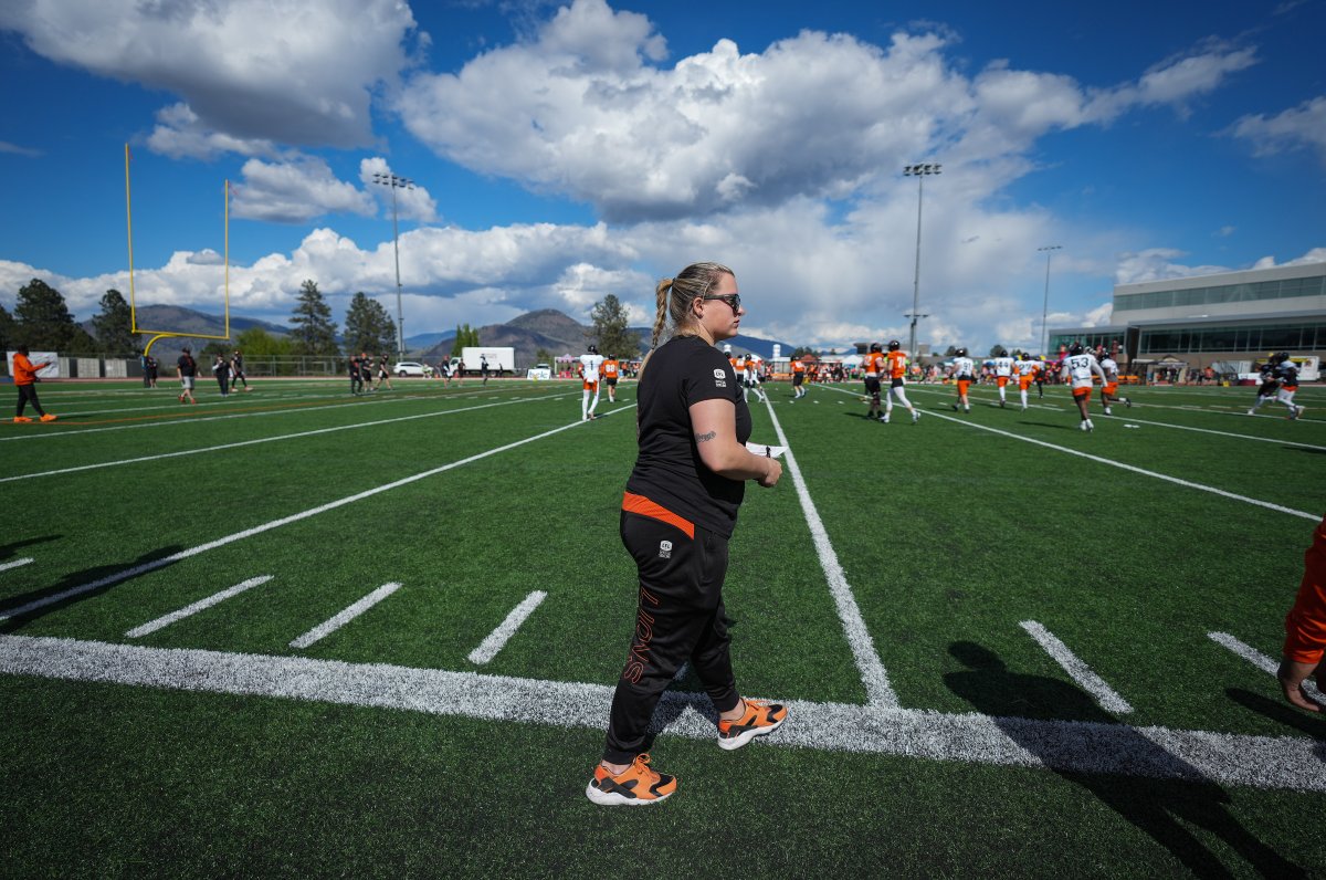 B.C. Lions defensive assistant Tanya Walter watches from the sideline during training camp in Kamloops in 2022. As the CFL’s first full-time female coach, Walter knows she’s paving the way for future generations.