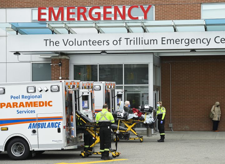 Paramedics transport an elderly man to the hospital's emergency department during the COVID-19 pandemic in Mississauga, Ont., on Thursday, November 19, 2020.