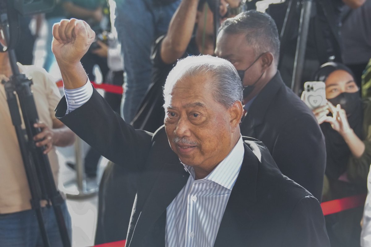 Malaysia's former Prime Minister Muhyiddin Yassin waves as he arrives at courthouse for a corruption charges in Kuala Lumpur, Malaysia, Friday, March 10, 2023. Muhyiddin, who led Malaysia from March 2020 until August 2021, will be the country's second leader to be indicted after leaving office. (AP Photo/Vincent Thian).