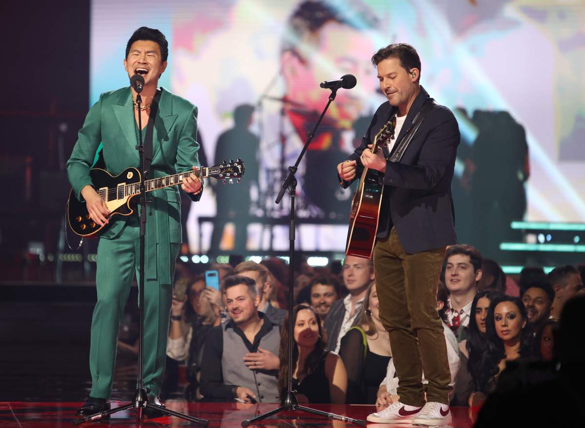 Simu Liu, left, and Ryan Peake of Nickelback perform during the Juno Awards in Edmonton on Monday, March 13, 2023. THE CANADIAN PRESS/Timothy Matwey