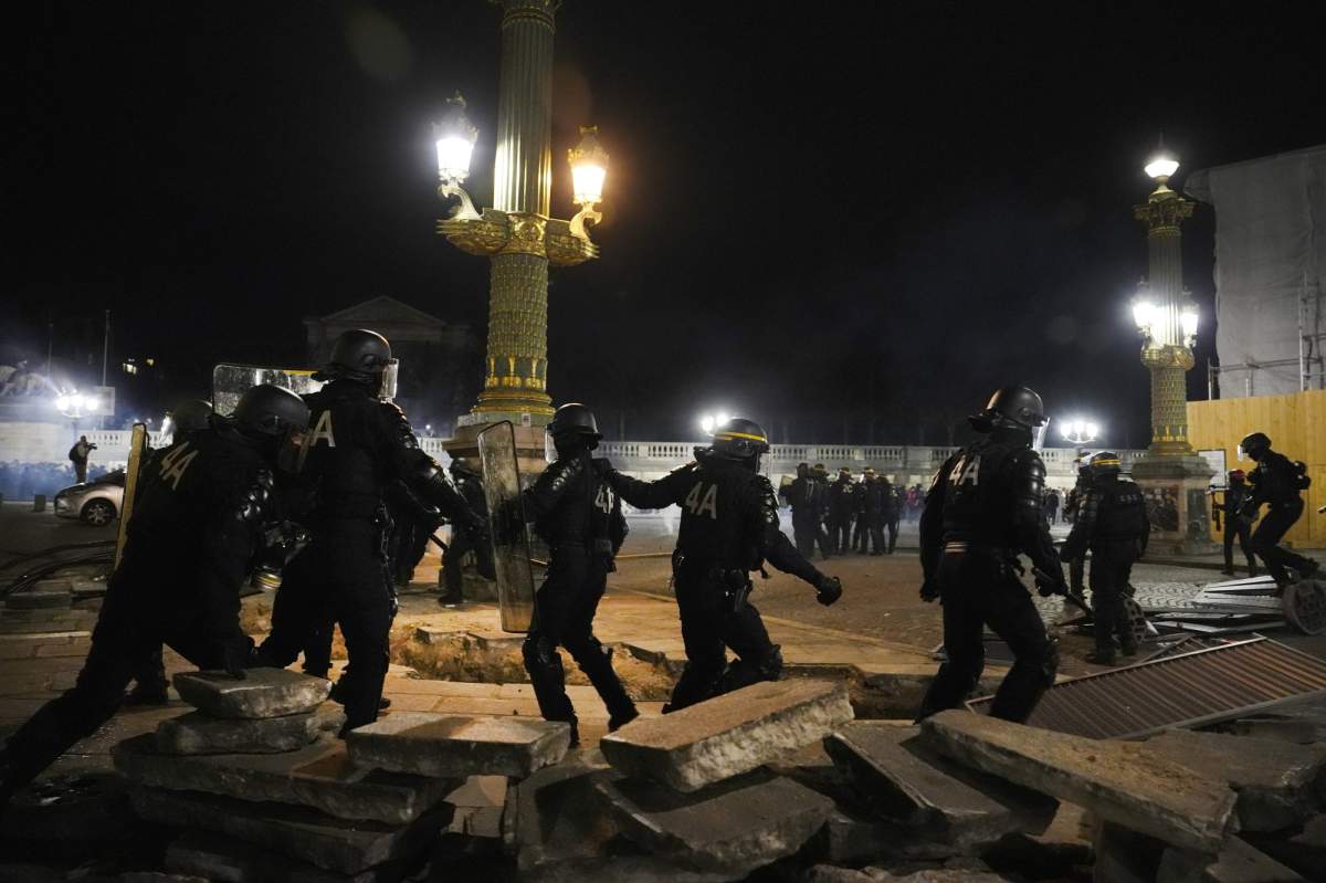 Police officers clear the Concorde square after a demonstration near the National Assembly in Paris, Thursday, March 16, 2023.