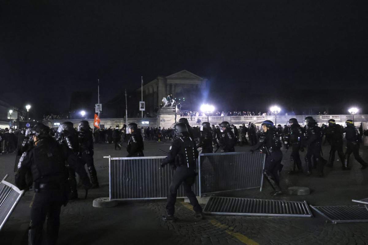 Policemen clear the protesters out of the Concorde square after a demonstration near the National Assembly in Paris, Thursday, March 16, 2023.