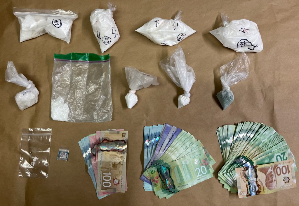 Police in Cobourg, Ont., seized drugs and cash as part of an investigation into a gunpoint robbery on March 1, 2023.