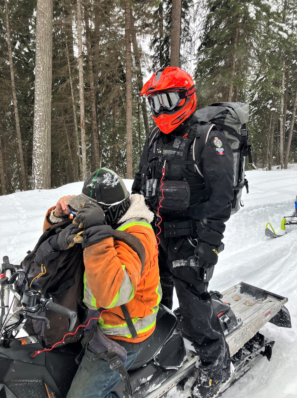 A B.C. conservation officer poses with a stranded miner rescued from his claim near Quesnel. 