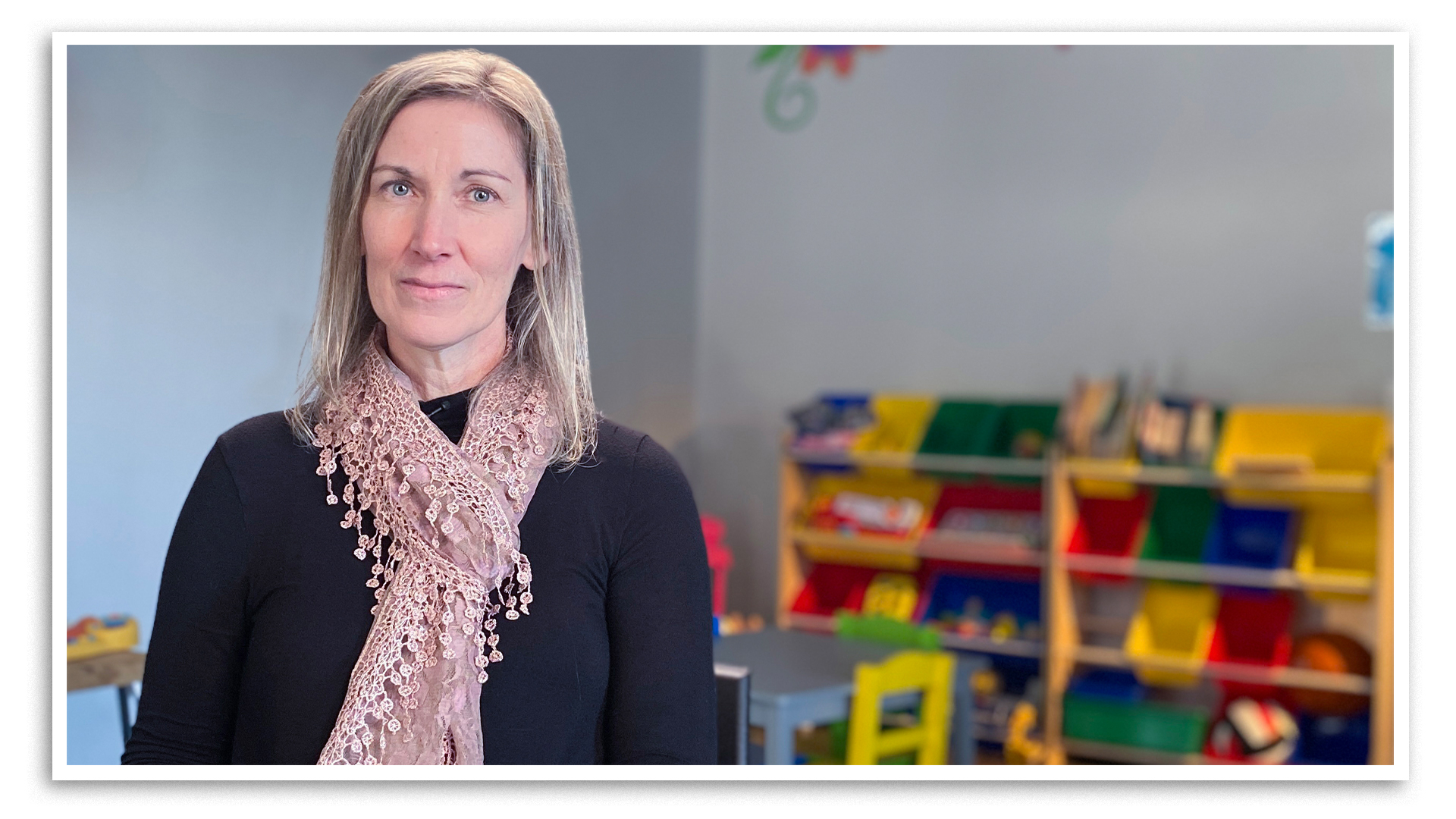 Dawn Flegel, the executive director of Sarnia-Lambton Children's Aid Society, sits in a room at her agency’s offices. There are colourful toys and a small table and chairs where children can play behind her. Flegel ended her agency’s use of group homes and has been fighting to keep kids with their families.