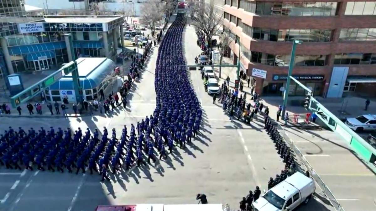 Thousands of police officers and first responders march in the regimental funeral procession for Const. Travis Jordan and Const. Brett Ryan as it moves from the Alberta legislature through downtown to Rogers Place in Edmonton, Alta. on Monday, March 27, 2023.