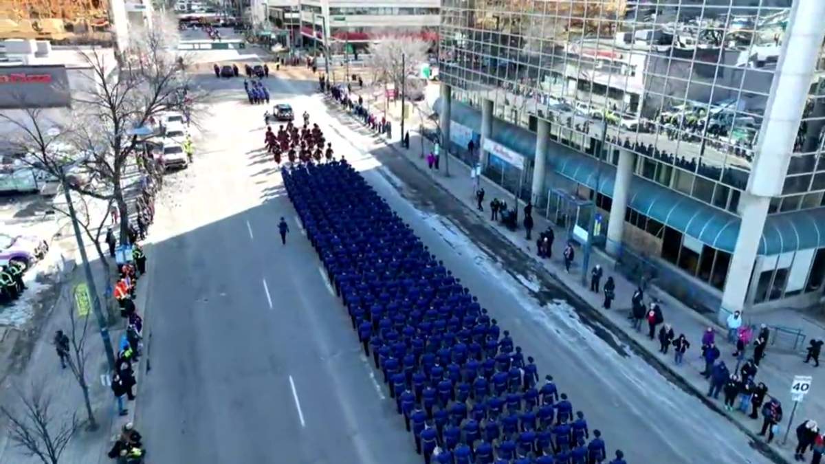 Thousands of police officers and first responders march in the regimental funeral procession for Const. Travis Jordan and Const. Brett Ryan as it moves from the Alberta legislature through downtown to Rogers Place in Edmonton, Alta. on Monday, March 27, 2023.