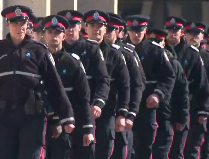 Hundreds of Edmonton police officers, Alberta first responders and other Edmontonians lined the streets of Alberta's capital on Tuesday to pay tribute to two slain constables as their bodies were taken to a funeral home.