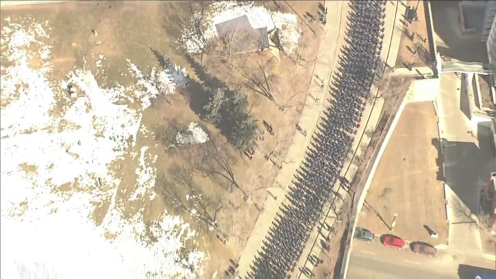 Police officers take part in a funeral procession for two slain Edmonton police officers on March 27, 2023.