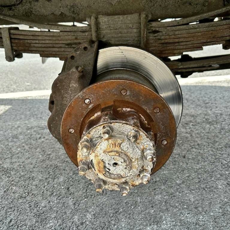 The driver of a commercial vehicle has been charged after a wheel broke off along Highway 404.