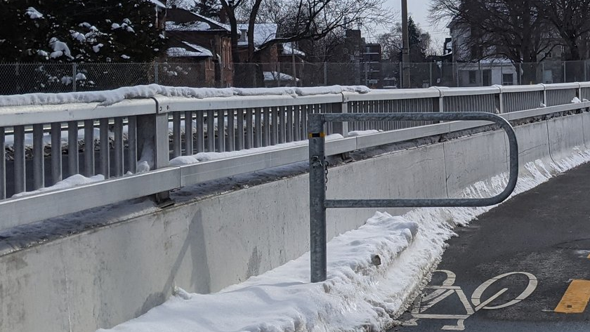 A barrier with an aluminum railing on the Keddy Access Trail in Hamilton.