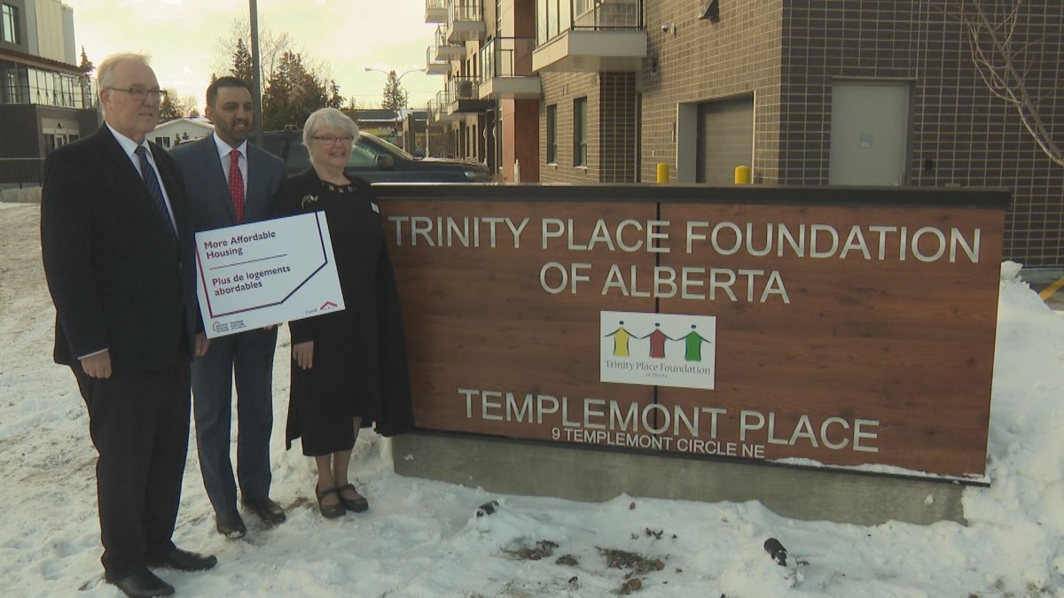 MPs Bill Blair and George Chahal, and Trinity Place Foundation chair Susan Mullie stand outside Templemont Place on March 14, 2023.