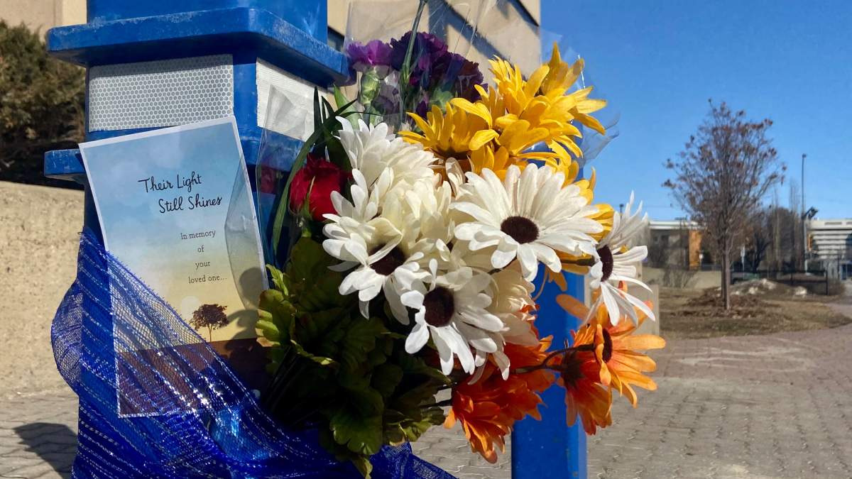 Flowers outside the Edmonton Police Service headquarters to honour Const. Travis Jordan, 35, and Const. Brett Ryan, 30, were killed early Thursday, March 16, 2023.