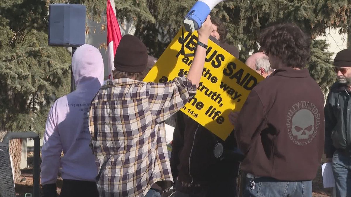 Protestors and counter-protestors clash at Calgary's Canyon Meadows Pool on Feb. 12, 2023.