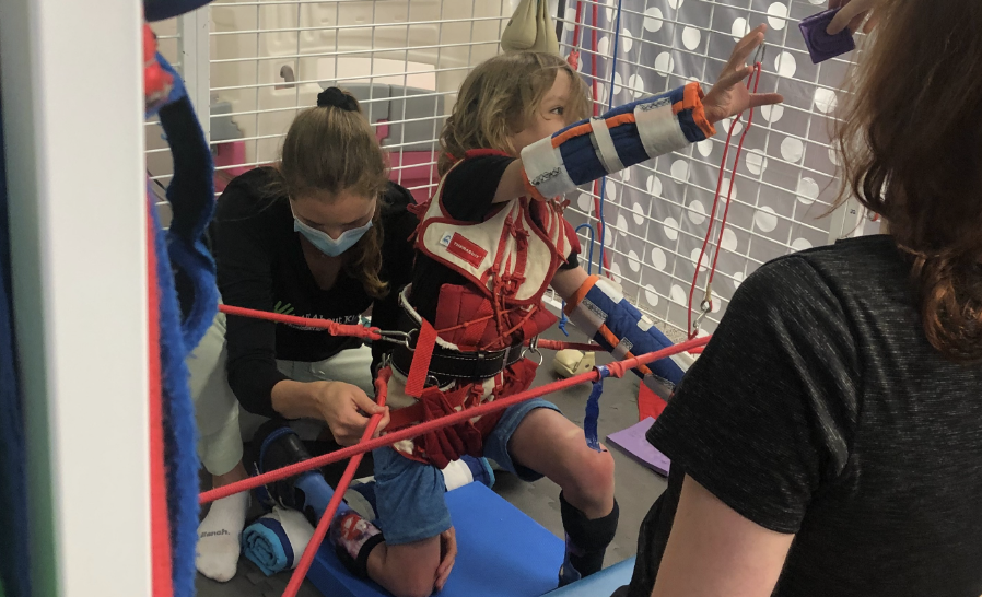Oliver at a therapy session focusing on balance and leg strength.