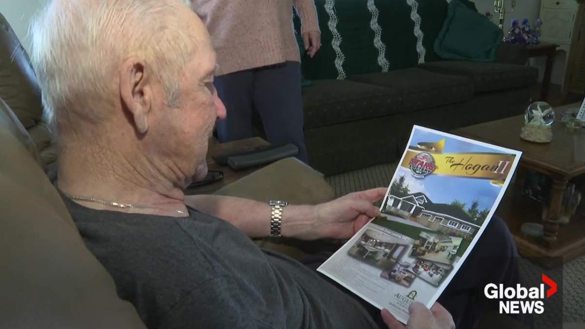 Neil Lund looking at the poster of the STARS Air Ambulance Calgary dream home worth $1.3 million he and his wife Mona Cardinal won in 2014.