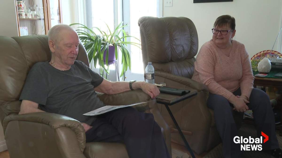 Neil Lund looking at the poster of the STARS Air Ambulance Calgary dream home worth $1.3 million he and his wife Mona Cardinal won in 2014.