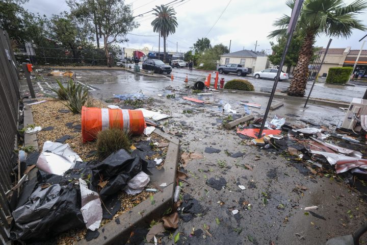 Debris is seen strewn across a parking lot and street