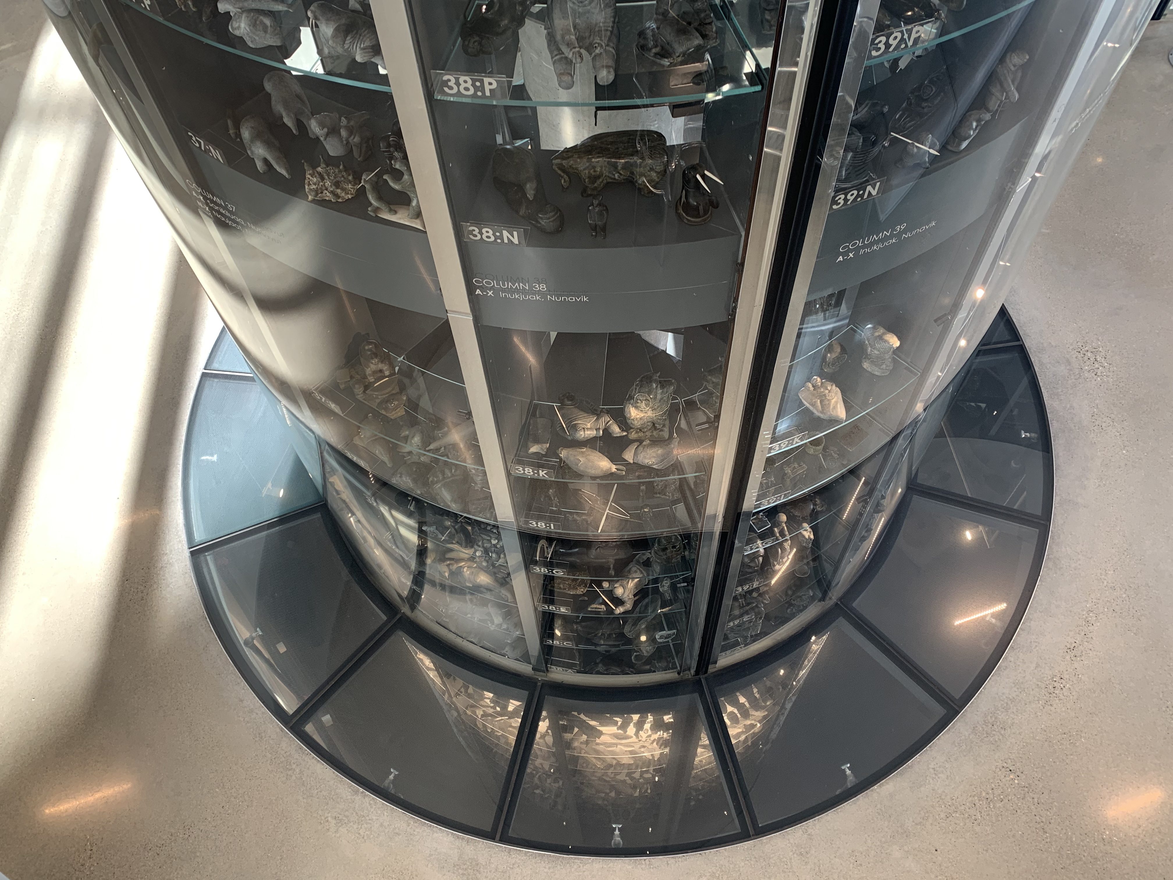 Two storeys of the Visible Vault are above ground and showcase stone carvings, while whalebone, ivory and antler is underground, out of direct sunlight. It's a round display case, made of glass and mirrors.