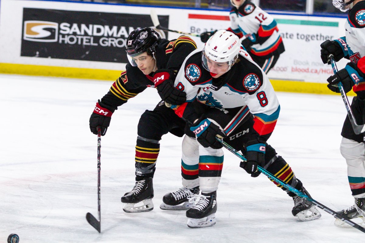 Grady Lenton of the Kelowna Rockets, right, and Damian Palmieri battle for the puck during WHL action in Kelowna, B.C., on Friday, March 10, 2023. Kelowna won 4-3 in a shootout.