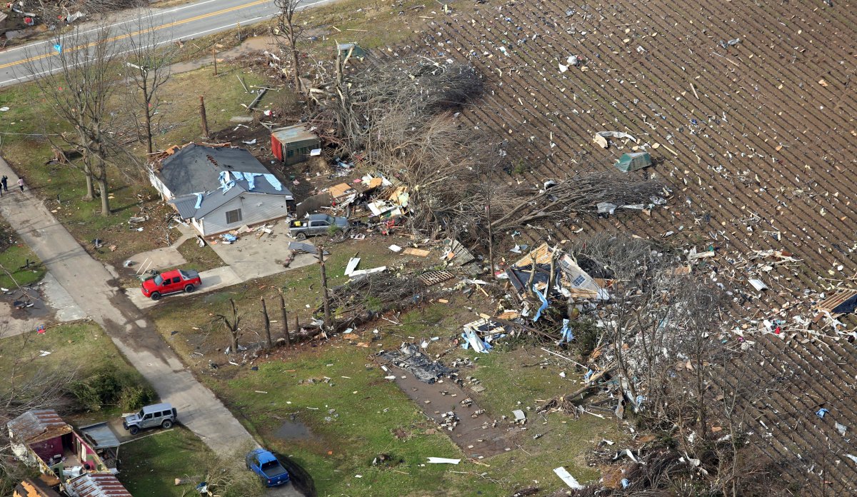 The damage of a powerful tornado is visible across a field.