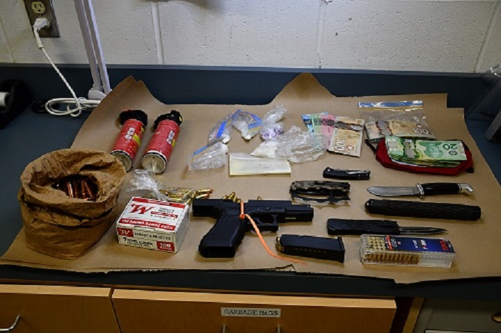 Cash, drugs and weapons seized during a raid of a home in Campbell River, B.C., earlier this month. 