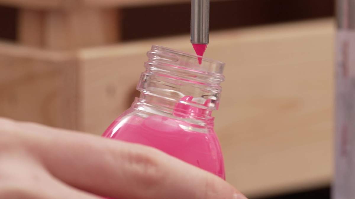 Filling a bottle of 'The Pinkest Pink' at Semple's paint lab.