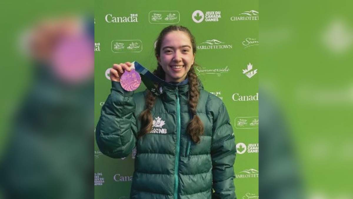 Scott holding her medal in PEI