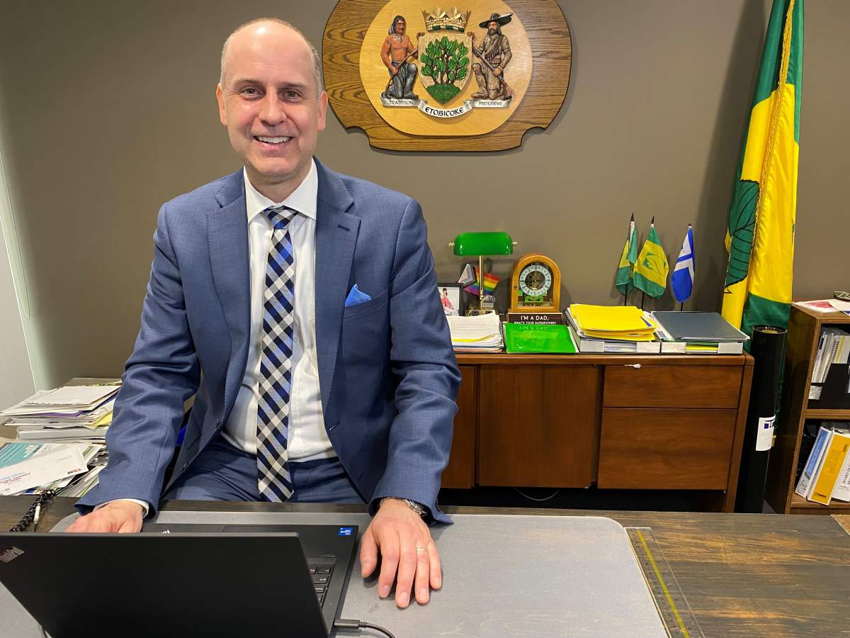 Councillor Stephen Holyday sits at his desk.