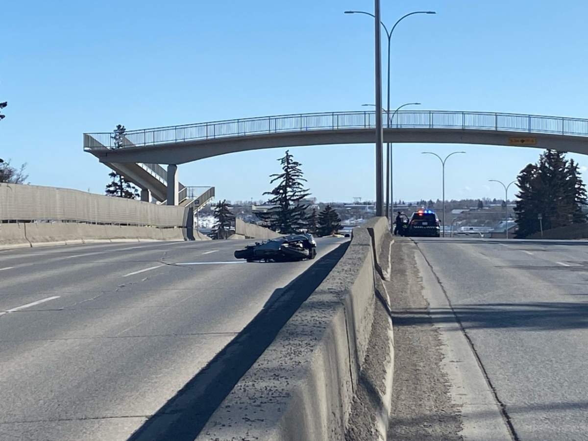 A motorcycle lays on its side on Macleod Trail following a fatal collision on March 31, 2023.