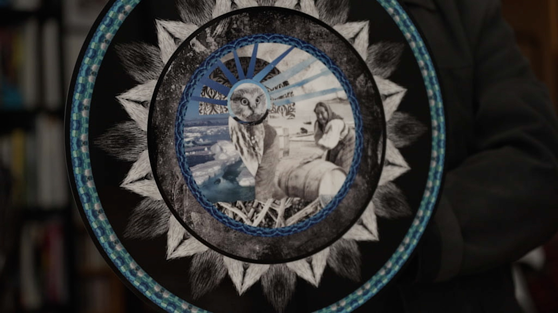 A collage created by multi-disciplinary artist and filmmaker, Glenn Gear, using photos from archives in Labrador. It's a round collage, with a white owl in the centre.