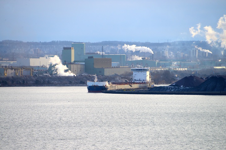 The ship Algoma Harvester unloads iron ore at Arcelor Mittal's dock in Hamilton, Ontario, on December 27, 2022.