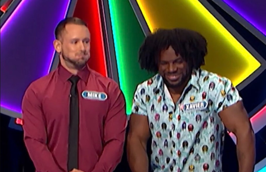 Mike Bozzuffi and Xavier Woods try to hold in their amusement.