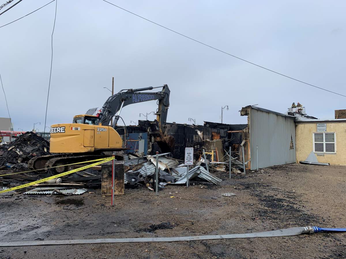 A commercial building at Stony Plain Road and 156 Street in Edmonton was burned and then demolished on Friday, April 14, 2023.