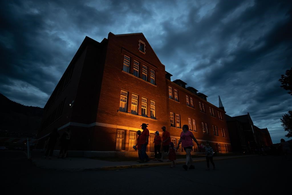 A growing number of Canadian corporations are pursuing cultural awareness training in order to get better at recruiting and retaining Indigenous employees. People are silhouetted as they walk past the former Kamloops Indian Residential School in Kamloops, B.C., on Monday, May 31, 2021.