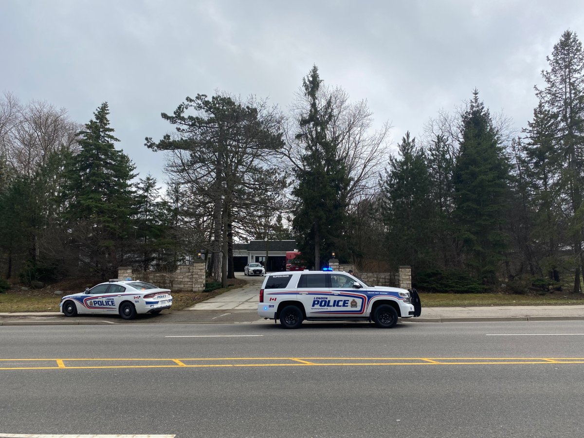 Police cruisers stationed outside a home in the 400-block of Commissioners Road East on April 4, 2023.