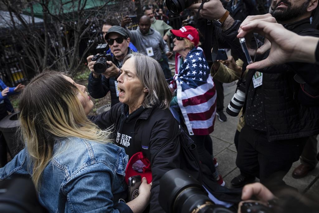 Protesters argue at the Collect Pond Park across the street from the Manhattan District Attorney’s office in New York on Tuesday, April 4, 2023. Former President Donald Trump will surrender in Manhattan on Tuesday to face criminal charges stemming from 2016 hush money payments. (AP Photo/Stefan Jeremiah)