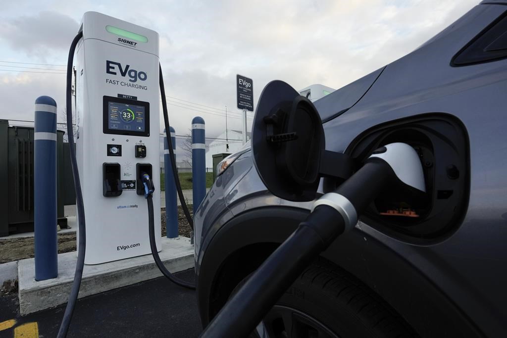 FILE - An electric vehicle charges at an EVgo fast charging station in Detroit on Nov. 16, 2022. (AP Photo/Paul Sancya, File).