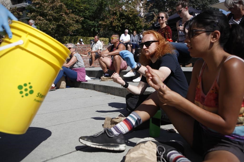 Alex Delongchamp and Gurman Tatla take part in a mass group naloxone training seminar during International Overdose Awareness Day at Centennial Square in Victoria, B.C., on Sat. Aug. 31, 2019.