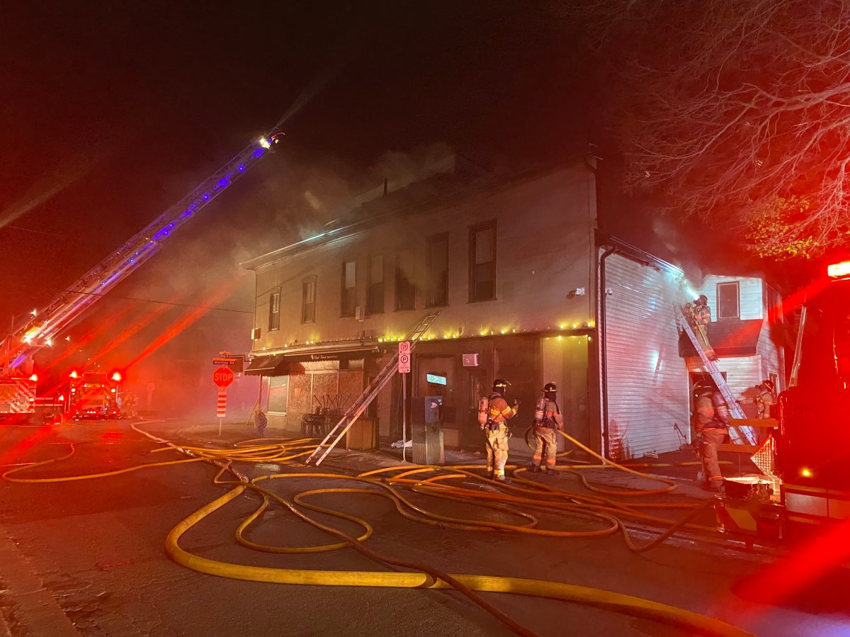 Crews battle a fire at 134 Wortley Rd. in London, Ont. in the early morning hours of April 16, 2023.